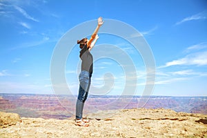 Young lady at the edge of the Grand Canyon rim