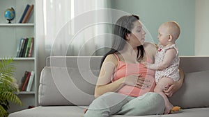 Young lady expecting child, enjoying time with little baby, happy motherhood