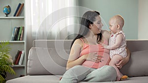 Young lady expecting child, enjoying time with little baby, happy motherhood