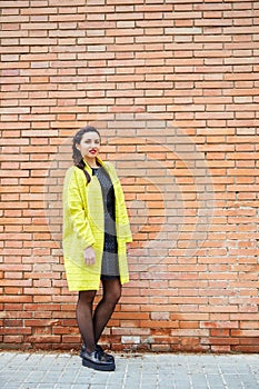 Young Lady in front of a brick wall