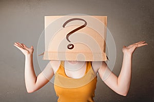 Young lady gesturing with a cardboard box on her head with quest