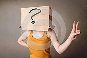 Young lady gesturing with a cardboard box on her head with quest photo