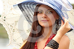 Young lady in hat with an umbrella