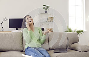 Cheerful woman using smartphone laughing gossiping and discussing news with her friend.