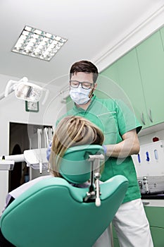 Young lady having her teeth examined