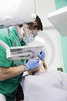 Young lady having her teeth examined by a dentist