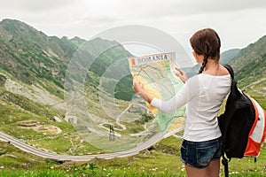 Young lady hiker holding map