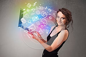 Young lady holding notebook with colorful hand drawn multimedia