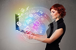 Young lady holding notebook with colorful hand drawn multimedia