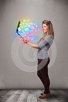 Young lady holding notebook with colorful hand drawn multimedia