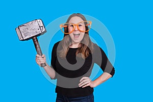 Young lady holding a rubber mallet hammer photo prop and big orange glasses photo booth portrait