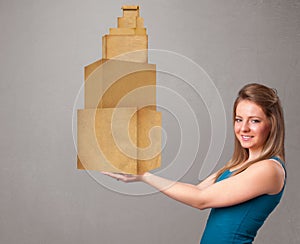 Young lady holding a set of brown cardboard boxes