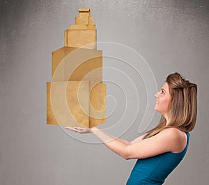 Young lady holding a set of brown cardboard boxes