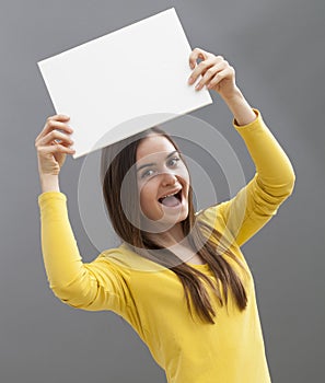 Young lady holding up blank board for your commercial