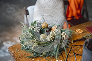 A young lady joins a workshop to create festive Christmas ornaments.