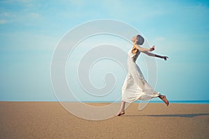 Young lady jumping on the beach