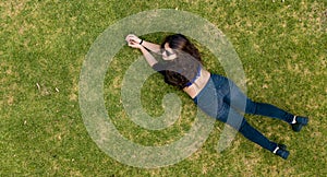 Young lady laying in the grass photo