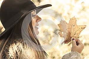 Young lady with leaf outdoor