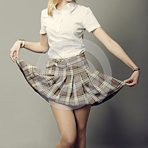 Young lady lifting up her short skirt