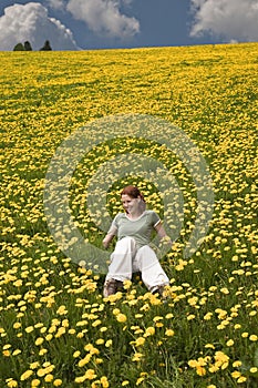 Young lady in the meadow full of flowers