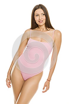 Young lady in one piece swimsuit posing on white