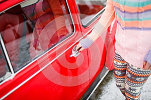 Young lady opening car door close-up. Favourite present concept