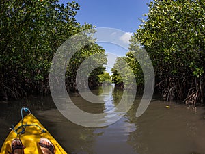 Young lady paddling hard the sea kayak with lots