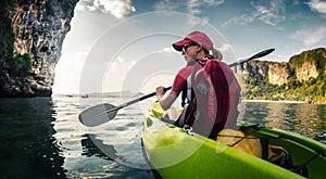 Young lady paddling kayak
