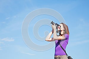 Young lady photographer outdoors