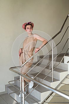 Young lady posing on the stairs inside building