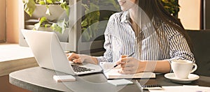 Young lady searching information in internet on laptop