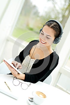 Young lady selecting a tune from her music library photo