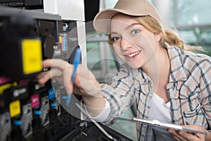 young lady servicing photocopier