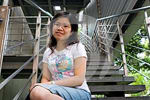 Young lady sitting at stair