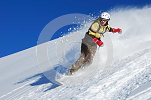 Young lady snowboarder riding