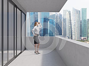 Young lady is standing on the balcony of the skyscraper and looking at the new business perspectives. Singapore panoramic