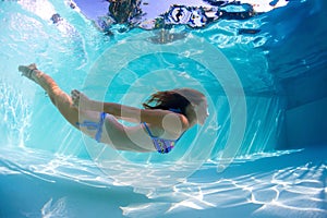 Young lady swimming underwater