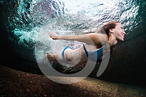 Young lady swimming underwater