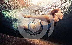 Young lady swimming underwater