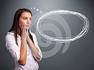 Young lady thinking about speech or thought bubble with copy spa