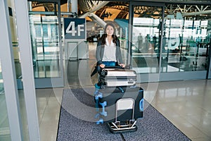 Young lady traveler rolling the cart arrive