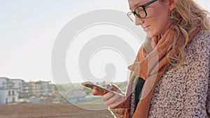 A Young Lady Using a Smartphone Outdoors