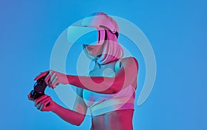 Young lady in VR helmet playing video game