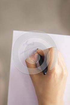 Young lady writing on paper