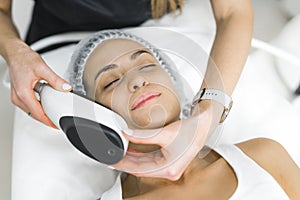 Young Latin American Woman getting an professional facial beauty treatment in spa