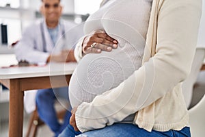 Young latin couple doctor and patient having medical consultation at clinic