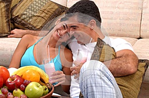 Young latin couple drinking strawberry milkshake