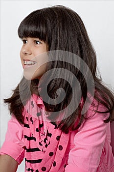 Young Latin Girl With Silky Hair & Colored Braces