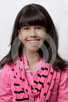 Young Latin Girl Smiling With Colored Braces
