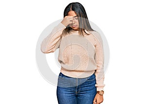 Young latin girl wearing wool winter sweater tired rubbing nose and eyes feeling fatigue and headache